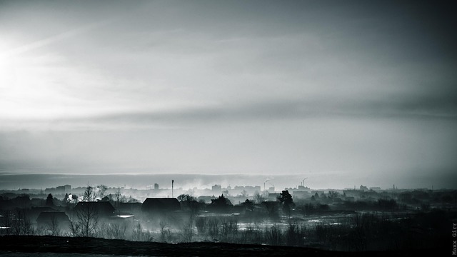 Construction site with builders laying drainage pipes in trenches for a new housing development on a clear day