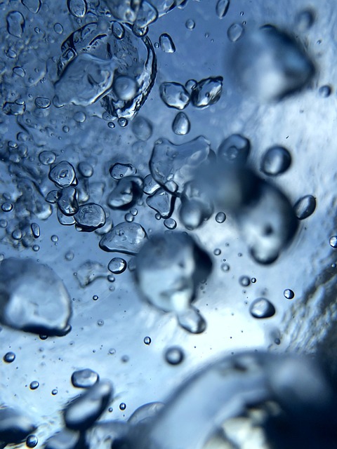 Close-up view of neatly stacked blue MDPE and orange HDPE construction pipes with clear diameter markings visible