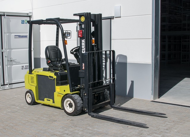 Forklift moving a pallet of blue MDPE water pipe coils through a spacious clean warehouse aisle