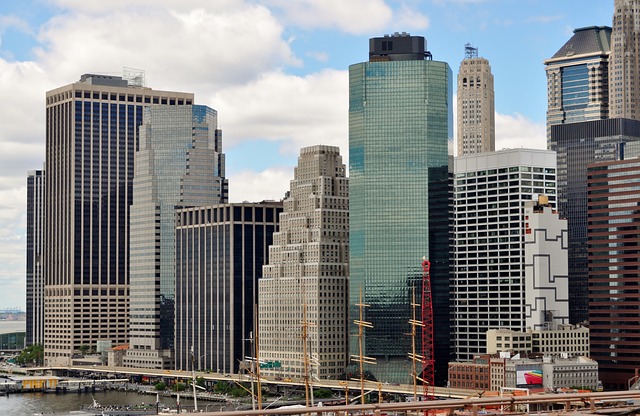 New residential housing estate under construction with plumbers installing copper pipe central heating systems in unfinished houses